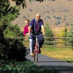 Picture of active couple riding a bike together